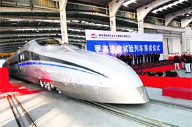 Workers unveil the new high-speed train, capable of reaching speeds up to 500 km (310 miles) an hour, at a ceremony in Qingdao in eastern China