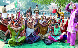 Members of the district unit of Mid-day Meal Workers Union Punjab (CITU) protest outside the Mini-secretariat in Bathinda on Tuesday