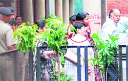 Former Punjab and Haryana High Court Judge Nirmal Yadav comes out of the district courts after hearing.