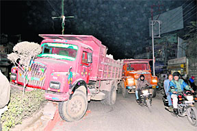 A truck that hit a road divider at Rajpur near Clock Tower in Dehradun on Tuesday evening. 