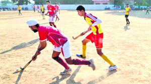 Players in action in a match in the All-India Swami Shraddhanand National Hockey Tournament in Haridwar on Tuesday. 