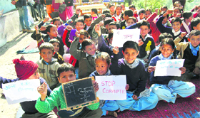 Schoolchildren hold placards in support of Anna Hazare at a government school in Shimla on Tuesday.