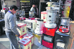 A man at an electronic shop in Jammu.