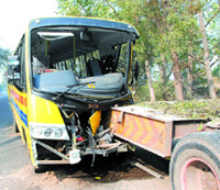 The damaged college bus that hit the truck carrying the boiler due to dense fog. 