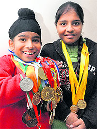 Gurnoor Singh and Gurpreet Kaur strike a pose with their medals in Chandigarh