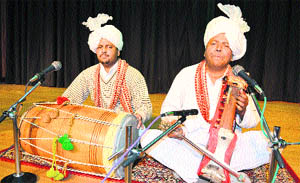 Puran Chand (right) sings Karakan songs at a show of Trikuta HIlls at an auditorium at Katra in Jammu on Wednesday. 