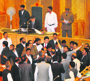 Opposition PDP MLAs create a ruckus in the Legislative Assembly Well in Srinagar on Tuesday during a protest demanding probe into the killing of 62-year-old NC worker Syed Mohammad Yusuf. 