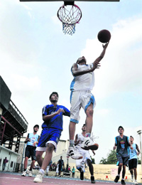 Players vie for the ball during a basketball match in Ludhiana. 