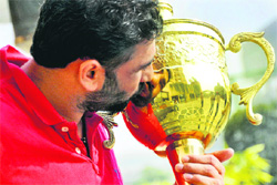 Sukhbir Singh Sarawan, captain of the Indian kabaddi team, kisses the trophy in Ludhiana. 