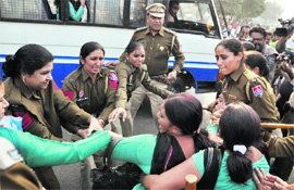 Police personnel push back protesting nurses at the Bharat Nagar Chowk on the Ferozpur Road in Ludhiana.