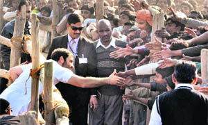 Congress general secretary Rahul Gandhi shakes hands with people during a rally in Sisaiya in Lakhimpur on Wednesday. 