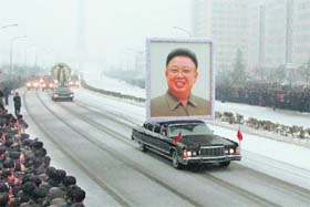 Final Farewell: A car carries a portrait of Kim Jong-Il during the funeral procession in Pyongyang on Wednesday