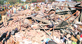 The municipal corporation demolishes illegal structures during an anti-encraochment drive near Dadu Majra, Chandigarh, on Thursday.