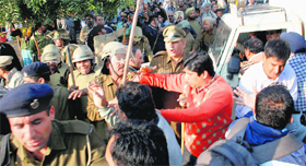 Panchkula police personnel push back mediapersons.