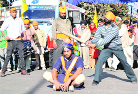 A Sikh devotee shows gatka skills during a nagar kirtan organised as part of the birth anniversary celebrations of Guru Gobind Singh in Dehradun on Thursday.