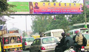 A file photo of a party hoarding on an overhead signboard near Bharat Nagar Chowk, Ludhiana. 