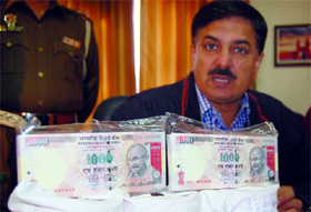 SSP (rural) Gurmeet Singh Chauhan shows fake currency and heroin seized in Amritsar on December 12.