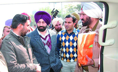 Officials question a man about the source of money (Rs 1. 60 lakh) seized during the checking at a naka in the city on Friday. The seized money is packet is held by a cop. Tribune photo: Pawan Sharma