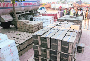 Policemen along with the liquor which was planned to be illegally ferried from Chandigarh to Punjab, at the Zirakpur police station on Friday. The accused are also seen in the picture. 