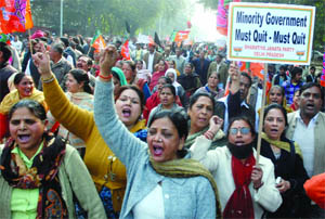 BJP activists shout anti-Congress slogans against the partys role in the Lokpal Bill and called it a murder of democracy in New Delhi on Friday. 