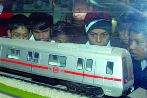 Homeless children admire a model on display at the Patel Chowk Metro station.