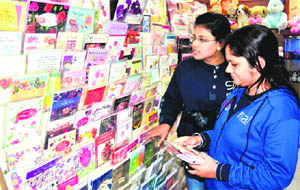 Two girls select New Year greeting cards at a card gallery in the Chandracharya Chowk market in Haridwar on Friday. 