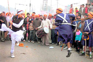 Devotees display martial skills during a nagar kirtan procession in Gurgaon on Friday.