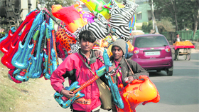 Vendors carrying plastic toys of different shapes in the Gandhi Nagar area of Jammu.