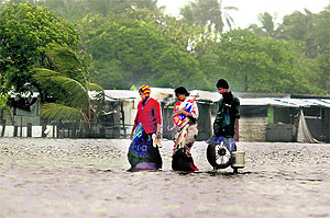 People at the Marina Beach after Cyclone Thane in Chennai on Friday. The cyclonic storm on Friday morning moved further westward and crossed north Tamil Nadu coast between Cuddalore and Puducherry