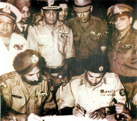 Lt-Gen A.A.K Niazi, commander of the Pakistani forces in East Pakistan (now Bangladesh) signing the surrender document with Lt-Gen J.S Aurora