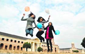 Three girls enjoy the last day of 2011 at the Forest Research Institute in Dehradun on Saturday