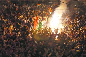 World at our feet: Euphoric cricket fans celebrate India's victory over Sri Lanka in ICC World Cup Cricket 2011 final match in Lucknow