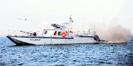 An Iranian navy vessel fires a missile in a drill in the sea of Oman on Friday.