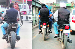 Youths ride bikes with blank or tiny number plates in Amritsar. 