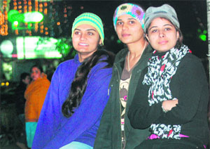 As fog sets in, girls don woollen caps in Sector 17, Chandigarh. 