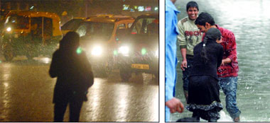 Traffic crawled in rain at ITO in New Delhi on Sunday.