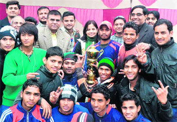 The Tehri Garhwal team with the 8th Uttarakhand State Softball Championship trophy in Haridwar on Sunday.