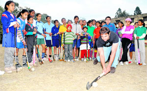Olympian Rahul Singh gives training to young hockey players in Dehradun on Saturday