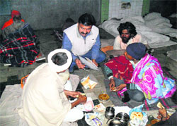 Shyam Sunder, Secretary of the Red Cross, listens to inmates problems at Makhan Lal Dharamshala in Yamunanagar on Sunday.