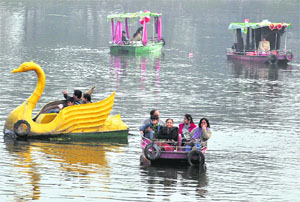 People enjoy boating on the New Year day at Karna Lake in Karnal on Sunday. 