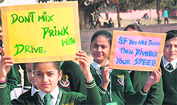 Schoolchildren take part in a rally on traffic awareness in Jammu on Sunday