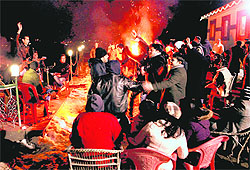 Tourists celebrate the New Year at the skiing resort of Gulmarg on Saturday