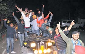 Youths dance their way on top of a jeep on the New Years Eve in Ludhiana