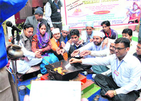 Members of a social club perform a 'yajna' while praying for a corruption-free government in the state, in Patiala on Sunday