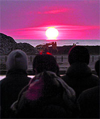 People watch the rising sun on New Years day at the tsunami struck Yuriage district of Natori city in Miyagi prefecture. A powerful 7.0-magnitude earthquake hit eastern and northeastern Japan on Sunday, rattling buildings in Tokyo and jolting the nation still recovering from last years quake-tsunami mega-disaster