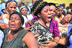 Relatives of the victims of Christmas day bomb explosion at St. Theresa's Catholic church in Madalla, just outside the capital Abuja, react during President Goodluck Jonathans visit to the church on Saturday