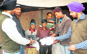 Noble Cause: Students from Postgraduate Government College, Sector 11, donate clothes and shoes to poor children in Chandigarh on Monday.