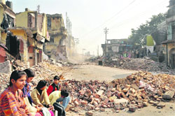 A demolition drive under way on Chakrata Road in Dehradun on Monday. 