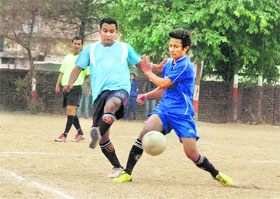 A match in the Amar Shaheed Kharag Bahadur Bisht Memorial Football Tournament under way in Dehradun on Monday.