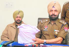 SSP (Rural) Yurinder Singh Hayer shows the opium seized from Gobind Ram in Jalandhar